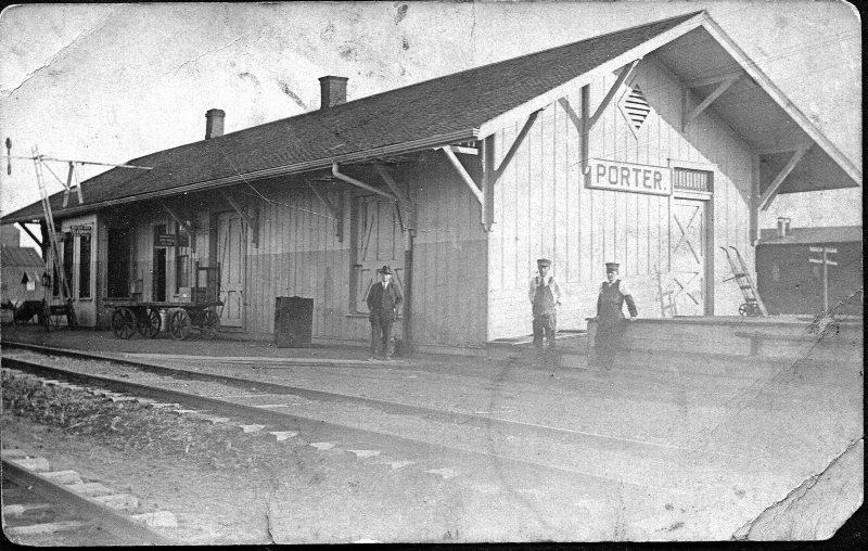 Black and white photo of white depot building