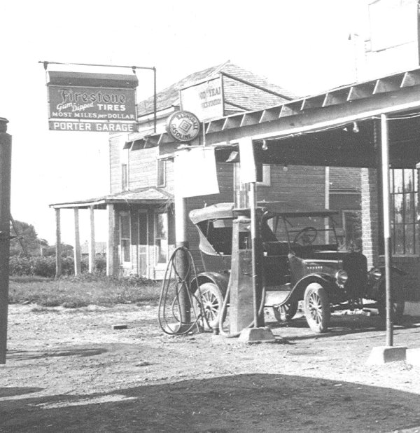 Black and white photo of black vintage care under roof
